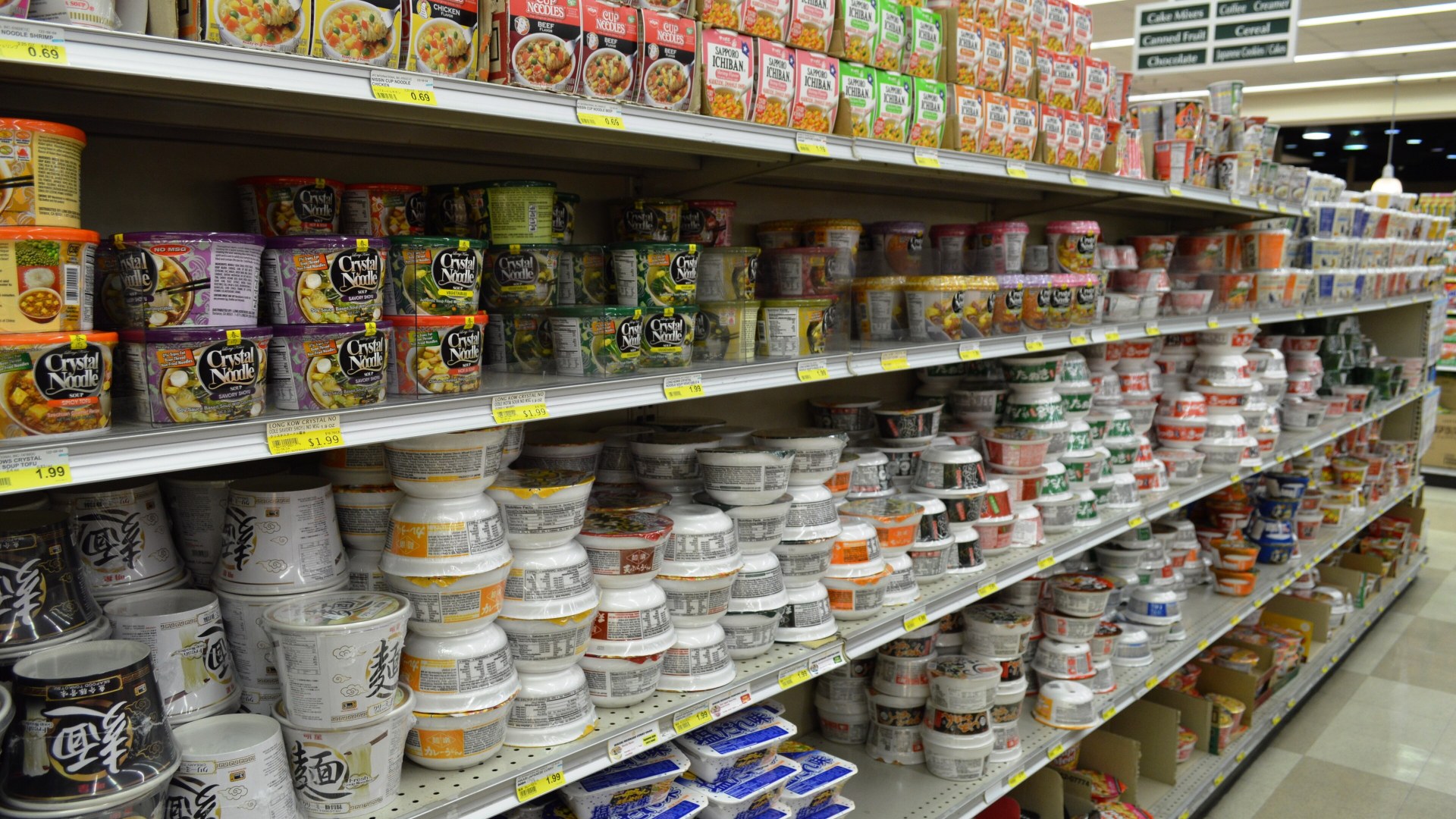 Shelves of packaged instant noodle soup cups