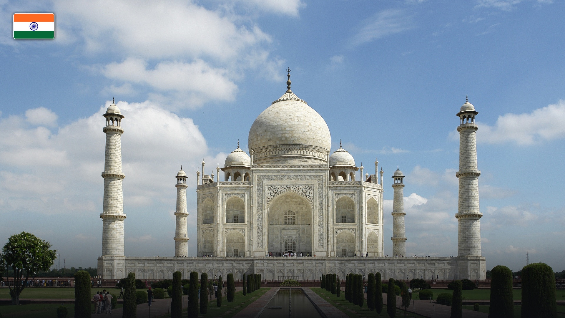 The white marble Taj Mahal and reflecting pool in Agra, with the flag of India.