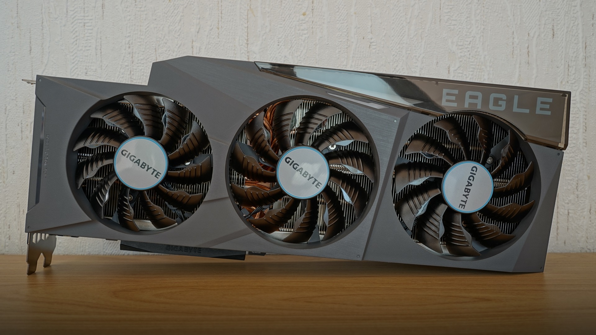 Front view of a triple-fan NVIDIA GeForce RTX 3090 graphics card showing large cooling heatsink and PCI Express connector.