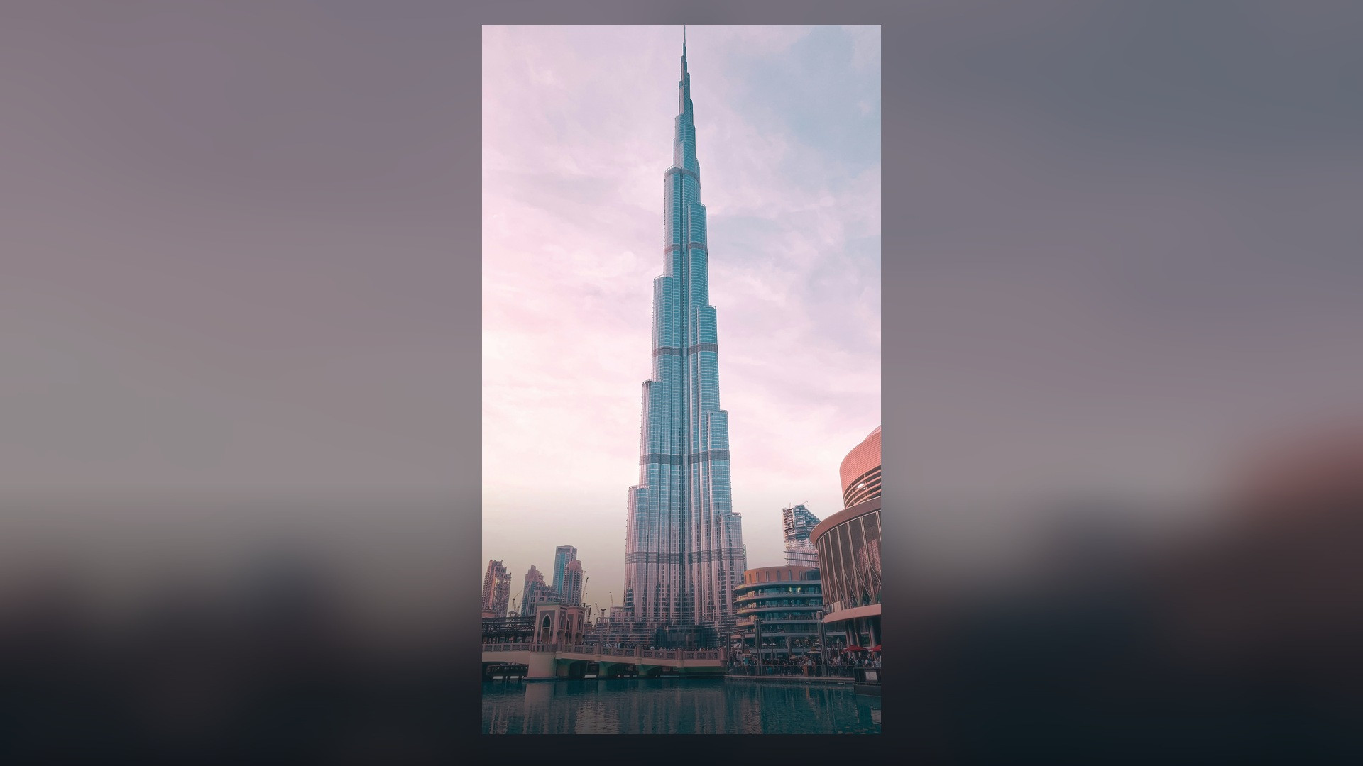 Burj Khalifa soaring in crystal-clear vertical perspective into the blue sky above Dubai.
