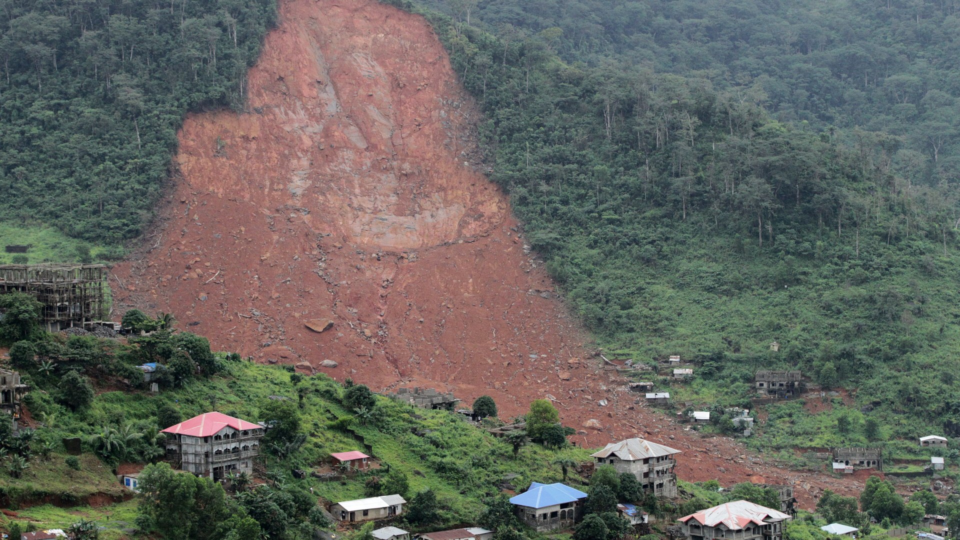 Red mud and boulders covering the hillside and destroyed homes after the August 2017 Sugar Loaf Mountain mudslide in Freetown, Sierra Leone.