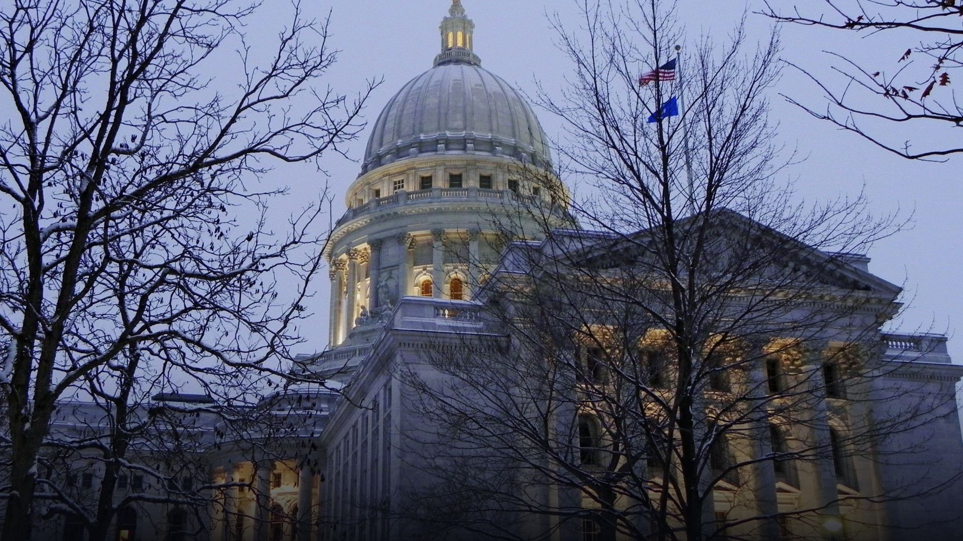 The Wisconsin State Capitol illuminated under a deep blanket of freshly fallen snow.
