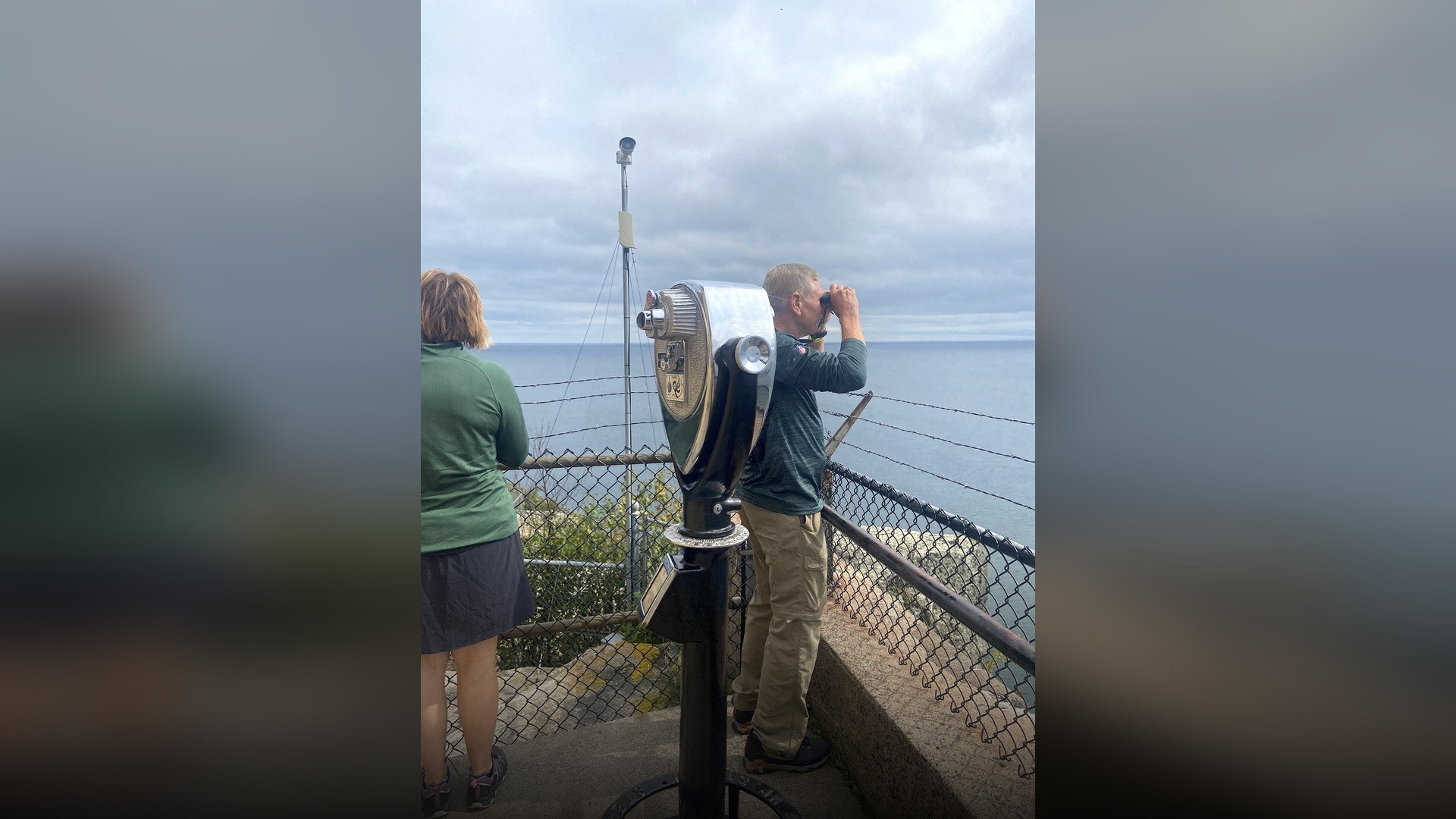 Split Rock Lighthouse standing sentinel atop a rocky cliff edge over Lake Superior.