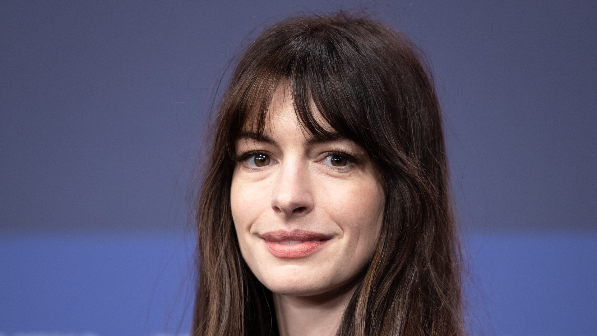 High-resolution red carpet photograph of Anne Hathaway looking directly into the camera with poised expression.