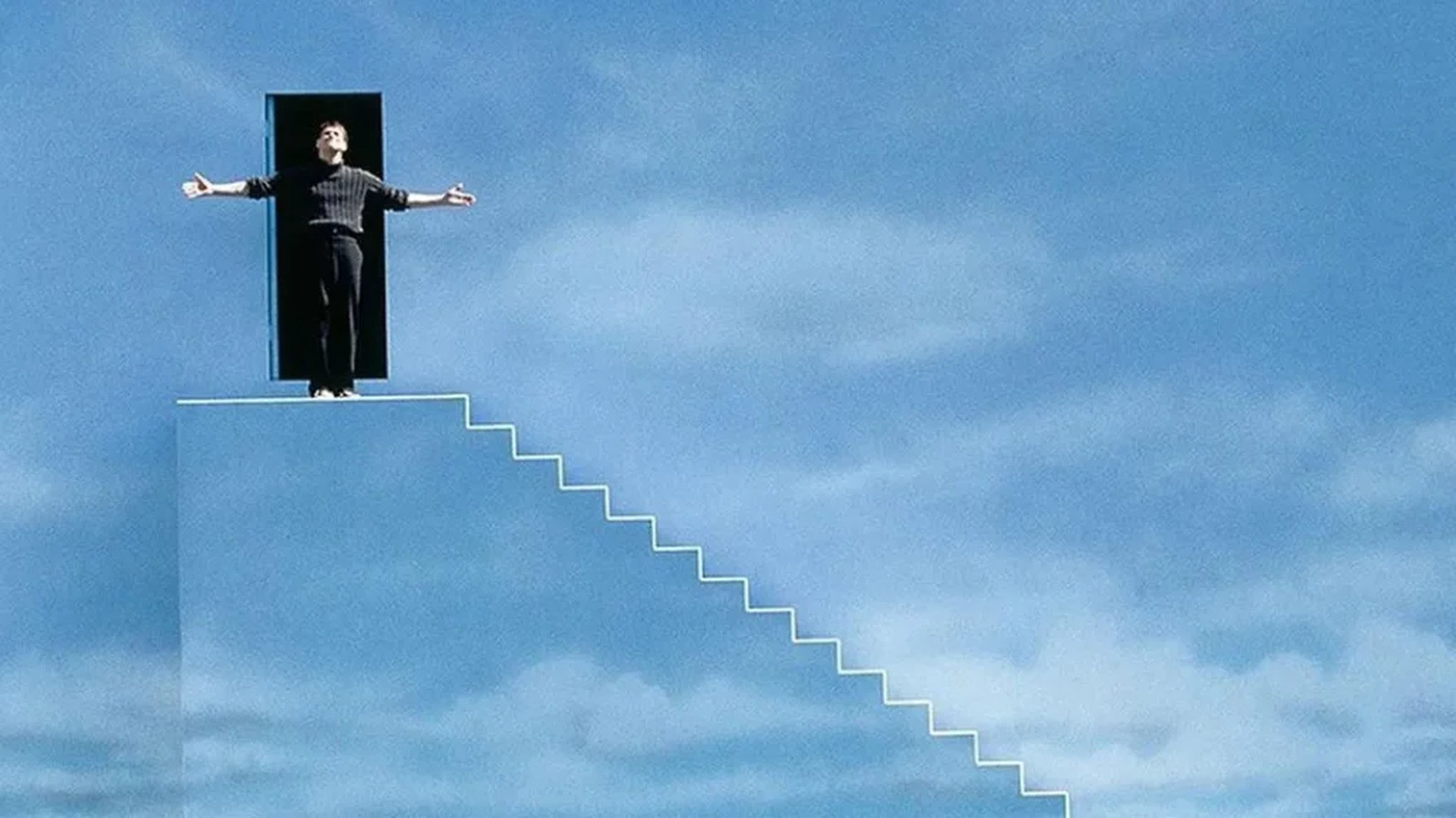 Truman Burbank in his business suit looking upward toward the artificial sky of Seahaven, image horizontally flipped.