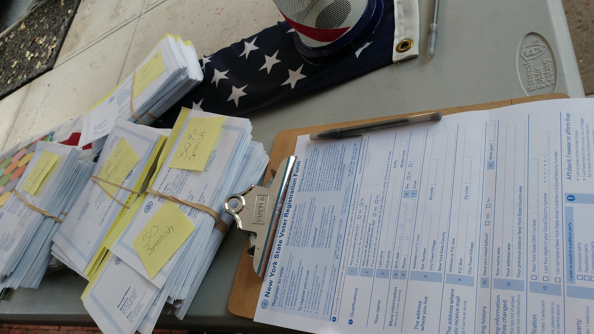 Official voter registration forms on table during registration drive.
