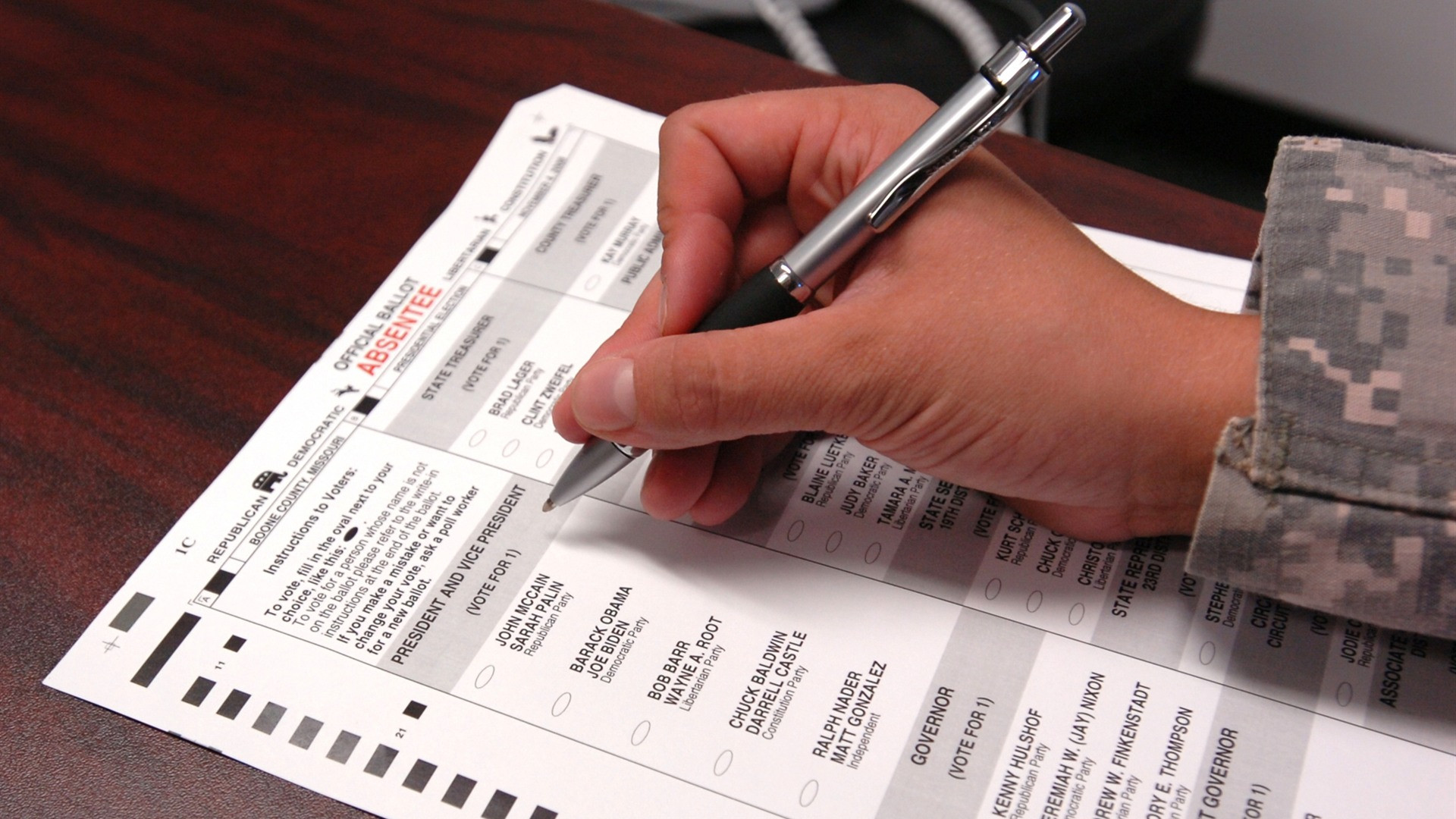 U.S. military service member completing an official absentee voting ballot.